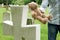 Father Placing Teddy Bear On Child\'s Grave In Cemetery