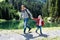 Father Playing With Child Girl At Mountain Lake In Austria