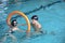 Father playing with daughter in swimming pool