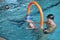 Father playing with daughters in swimming pool