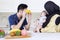 Father playing fruit with baby in kitchen