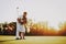 Father Playing Golf with Little Daughter on Field.