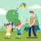 Father playing with kids and flying kite outdoors