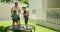 Father playing with kids on trampoline 4k