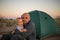 A father plays with his baby son at the tent in campground of Ho