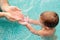 Father pouring water in hands of his son