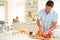 Father Preparing Family Breakfast In Kitchen