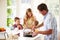 Father Preparing Family Breakfast In Kitchen