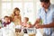 Father Preparing Family Breakfast In Kitchen