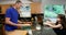 Father preparing food while daughter using laptop in kitchen 4k