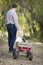 Father Pulling Baby Girl in Wagon with Christmas Tree