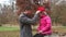 Father putting red cap on daughter\'s head