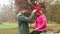Father putting red cap on daughter\'s head