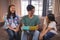 Father receiving greeting card and gift box from siblings in living room