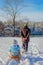 Father rides children on a sled. Walking on a frosty winter day in nature with family