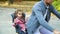 Father riding bicycle with daughter sitting in child seat