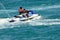 Father riding a jet ski with his toddler son on board