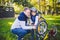 Father`s day Caucasian dad and 5 year old son in the backyard near the house on the green grass on the lawn repairing a bicycle,