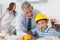 Father showing son his blueprints as he is wearing hardhat