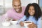 Father Sitting With Daughter Eatting Breakfast