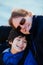 Father sitting with disabled son along lake shore