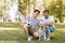 Father sitting near pleased teenager son