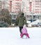 Father sledding his little girl