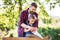 Father with a small daughter outside, making wooden birdhouse.