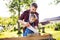 Father and a small daughter with a saw outside, making wooden birdhouse.