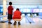 Father and son awaits patiently for bowling ball