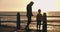 Father, son and beach in sunset, parent and boardwalk for leisure, talking and child. Conversation, nature and ocean for