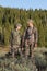 Father and son bow hunting together in woods