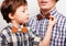 Father with son in bowties on white background,