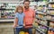 Father and son buy product in grocery store. Family in shop.