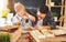Father and son carved of wood in carpentry workshop