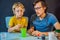 Father and son conduct chemical experiments at home. Home made slime