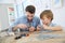 Father and son constructing an aeroplane toy