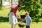 Father and son cooking meat on barbecue grill