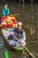 Father and son delivering flowers to market in a traditional shikara boat at Dal Lake