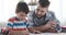 Father and son doing homework together at home