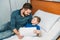 Father and son drawing together in hospital chamber