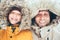 Father and son dressed in Warm Hooded Casual Parka Jacket Outerwear walking in snowy forest cheerful smiling faces portrait.