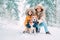 Father and son dressed in Warm Hooded Casual Parka Jacket Outerwear walking with their beagle dog in snowy forest cheerful