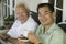 Father and son drinking coffee outdoors (portrait)