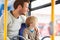 Father And Son Enjoying Bus Journey Together