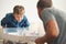 Father with son enthusiastically playing with table hockey