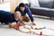 Father and son family time together at home concept. Bearded olf Father and Bearded middle age Son Playing Toy train on floor at