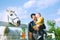 Father and son are feed a horse at countryside.