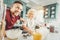 Father and son feeling cheerful while baking fruit pie