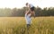 Father and son in a field at sunset. The father tosses his son up. Happy family concept.